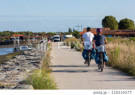 Person riding a bicycle on a cycle path 118310377