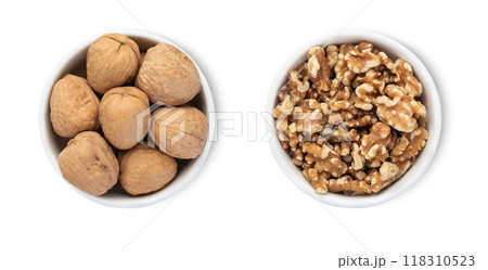 Bowls with organic walnut nuts isolated on white background.Top view. 118310523