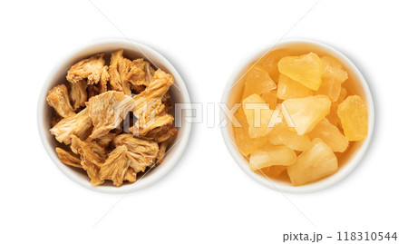 Bowl plates with sweet dried pineapple pieces isolated on white background.Top view. 118310544