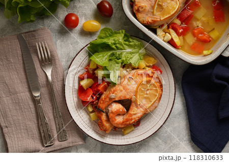 Baked salmon with vegetables on a dark background Baked salmon with vegetables on a dark background 118310633