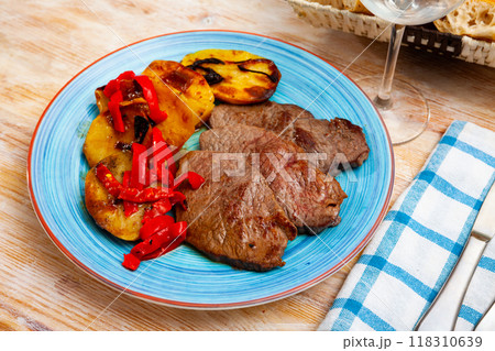 Tasty veal baked with potatoes and peppers served at plate 118310639