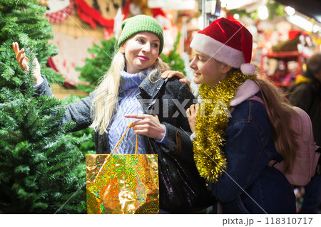 Woman and her teenage daughter at christmas fair Woman and her teenage daughter at christmas fair 118310717