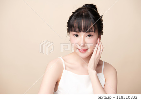 Beautiful young asian woman with clean fresh skin on beige background, Face care, Facial treatment, Cosmetology, beauty and spa, Asian women portrait. Beautiful young asian woman with clean fresh skin on beige background, Face care, Facial treatment, Cosmetology, beauty and spa, Asian women portrait. 118310832