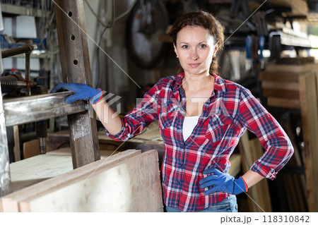 Portrait of confident female worker in workshop of metallurgical plant 118310842