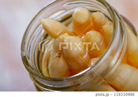 Glass jar with pickled asparagus on a wooden table Glass jar with pickled asparagus on a wooden table 118310986