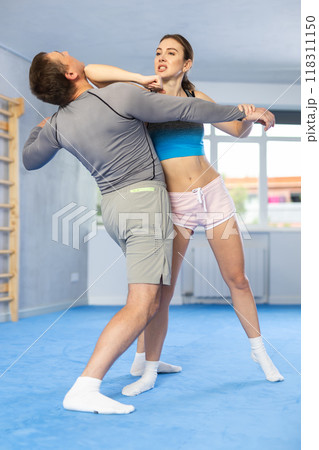 Woman and man practicing self defense techniques 118311150