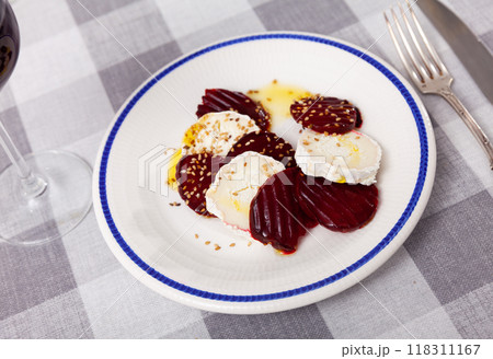Fresh baked beetroot and goat cheese salad on plate and decorated with sesame seeds. Healthy concept Fresh baked beetroot and goat cheese salad on plate and decorated with sesame seeds. Healthy concept 118311167