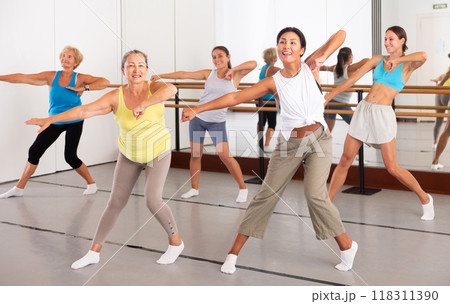 Group of dancers exercising modern dance movements in ball room 118311390