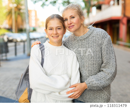 Portrait of a happy family - mom and teenage daughter on the street of autumn city 118311479