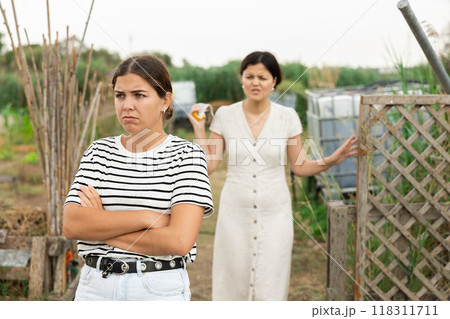 Farm neighbors quarrel over farm backyard in day Farm neighbors quarrel over farm backyard in day 118311711