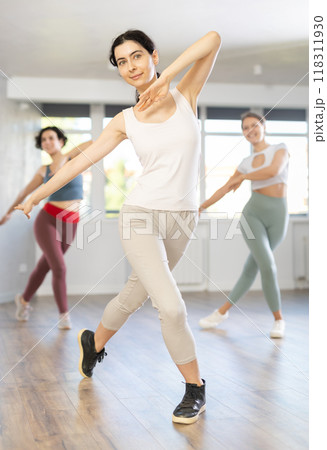 Group of women dancing modern dance in studio Group of women dancing modern dance in studio 118311930