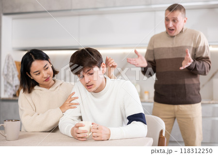 Domestic quarrel between relatives - father scolds and shouts at married couple 118312250