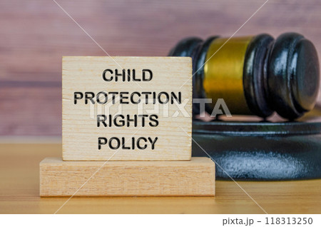 Child Protection Rights Policy text engraved on wooden blocks with gavel background Child Protection Rights Policy text engraved on wooden blocks with gavel background 118313250