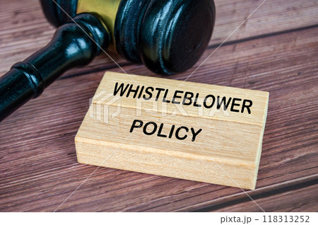 Whistleblower Policy text engraved on wooden blocks with gavel background Whistleblower Policy text engraved on wooden blocks with gavel background 118313252