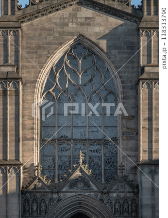 The Sun shines through the surface of Stained Glass Arched Windows and The Gable is above the entrance door of St. Giles Cathedral. 118313790