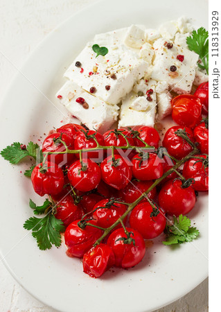 baked cherry tomatoes , with cheese, and spices, on a white plate, homemade, no people, baked cherry tomatoes , with cheese, and spices, on a white plate, homemade, no people, 118313929