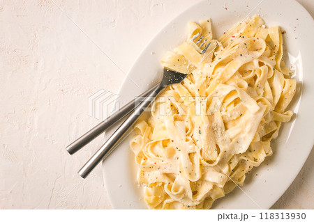 Fettuccine, tagliatelle, in creamy garlic sauce, Italian traditional cuisine, pasta carbonaro, Fettuccine, tagliatelle, in creamy garlic sauce, Italian traditional cuisine, pasta carbonaro, 118313930
