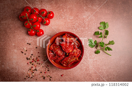 dried tomatoes, in a bowl, top view, on a brown background, dried tomatoes, in a bowl, top view, on a brown background, 118314002