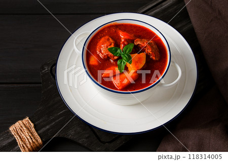 Stew with potatoes, in tomato sauce, with spices and herbs, close-up, no people, on a black background Stew with potatoes, in tomato sauce, with spices and herbs, close-up, no people, on a black background 118314005