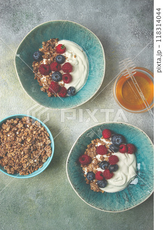 Breakfast, two bowls, yogurt, muesli with berries, and honey, homemade, no people, 118314044