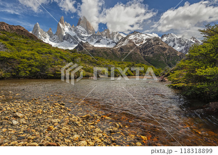 A beautiful river with stones in Los Glaciares national park with the Fitz Roy mountain range in background 118318899
