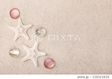 Border with star fish and red pebbles on white sand. Border with star fish and red pebbles on white sand. 118321610