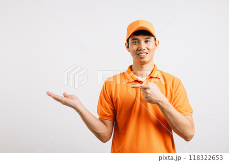 Portrait Asian smiling young delivery man points something with palm hands studio isolated white background, Happy lifestyle men carry person in an orange shirt uniform happy and positive mood Portrait Asian smiling young delivery man points something with palm hands studio isolated white background, Happy lifestyle men carry person in an orange shirt uniform happy and positive mood 118322653
