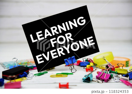 Learning for Everyone text on paper card with stationary on wooden background 118324353