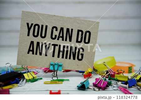 You Can Do Anything text on paper card with stationary on wooden background 118324778