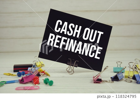 Cash Out Refinance text on paper card with stationary on wooden background 118324795