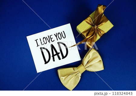 I love DAD card with bow tie and gift box Happy Father's Day concept on navy background I love DAD card with bow tie and gift box Happy Father's Day concept on navy background 118324843