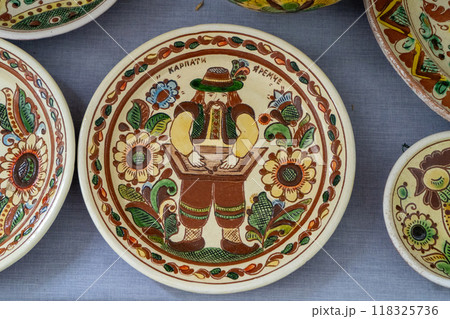 Ukrainian plates dishes. Clay ceramics food. Kosiv painting. Ukrainian plates dishes. Clay ceramics food. Kosiv painting. 118325736
