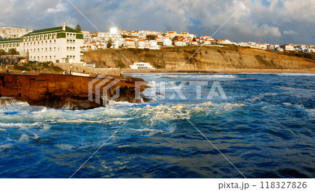 Aerial view - Beautiful travel destination with rocky shore during sunset. Drone view to Beautiful touristic town on Atlantic ocean background. Tourist place for surfing while vacation at Ericeira Aerial view - Beautiful travel destination with rocky shore during sunset. Drone view to Beautiful touristic town on Atlantic ocean background. Tourist place for surfing while vacation at Ericeira 118327826