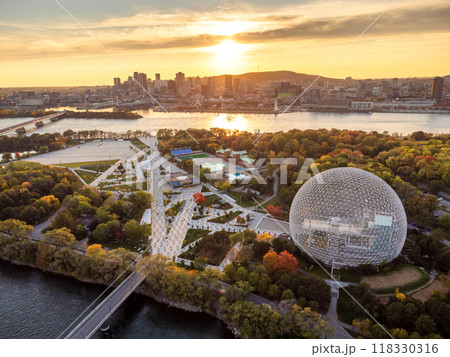 Aerial view of Montreal Biosphere in autumn sunset time, Jean-Drapeau Park, Saint Helen's Island. Montreal City downtown skyline in the background. Quebec, Canada. Aerial view of Montreal Biosphere in autumn sunset time, Jean-Drapeau Park, Saint Helen's Island. Montreal City downtown skyline in the background. Quebec, Canada. 118330316