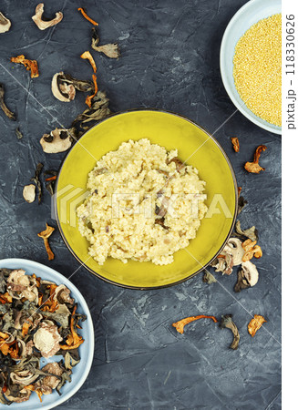 Bowl of millet porridge with mushrooms. 118330626