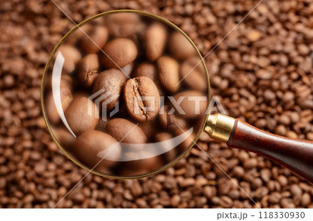 Coffee beans under a magnifying glass. 118330930