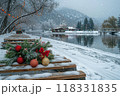 Snowy Benches and Holiday Decorations by a Calm Lake in a Wintery Mountain Village on a Cloudy Day 118331835