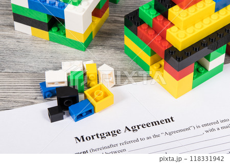 Houses made of toy blocks and mortgage agreement form 118331942