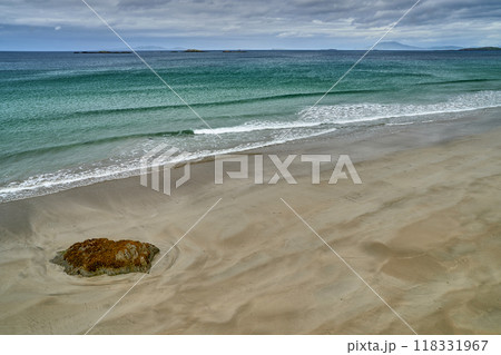 long exposure beach waves around rock cloudy day 118331967