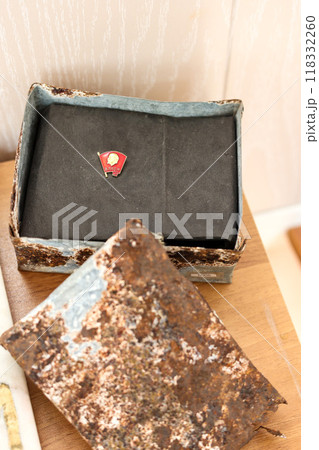 Orenburg, Russia - September 11, 2024 The insignia of the Komsomol movement of the Soviet Union in a time capsule for posterity. Editorial 118332260