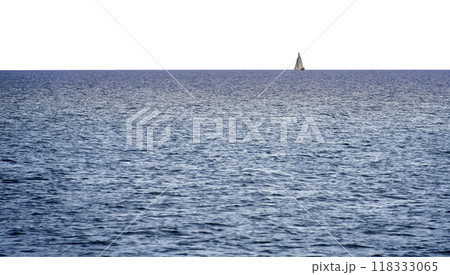 Lone small sailboat far away at the straight horizon at the edge of the sea 118333065