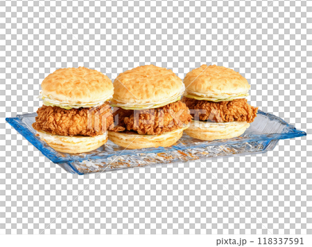 Fourth of July picnic fried chicken and biscuit sandwiches served on a transparent glass dish Fourth of July picnic fried chicken and biscuit sandwiches served on a transparent glass dish 118337591