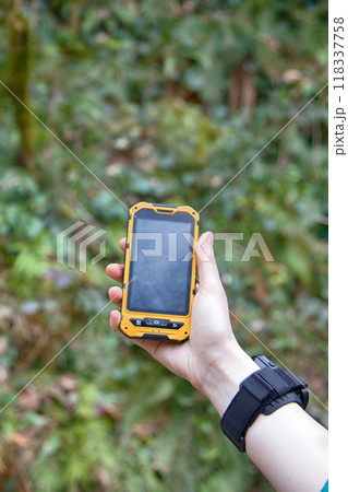 smartphone is ip68 protected in forest background. smartphone is ip68 protected in forest background. 118337758