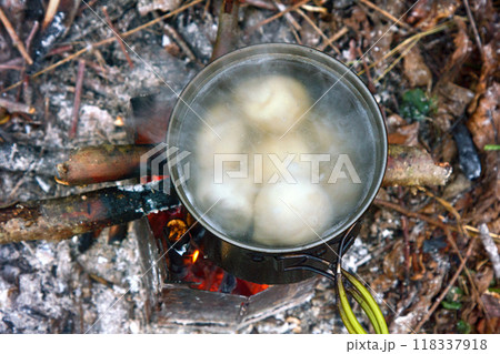 Cooking over open fire at campsite Cooking over open fire at campsite 118337918