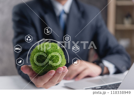 Businessman holding green grass globe with eco-friendly icons, symbolizing sustainability. Perfect for corporate responsibility, renewable energy, environmental conservation. green technology. 118338949