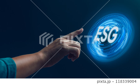 A hand reaching out to a futuristic, glowing ESG symbol, symbolizing the integration of Environmental, Social, and Governance principles in modern business practices. 118339004