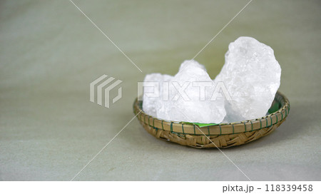 White crystal clear alum cube on brown background The chemical compound substance concept of spa and beauty industry. 118339458