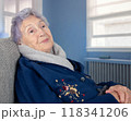 Senior Alzheimer's patient seated in a chair, indifferent and passive, illustrating the deep cognitive and motor decline caused by severe senile dementia and personality degradation. 118341206