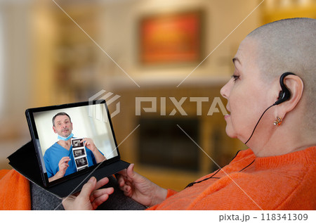 Patient receives breast cancer consultation via tablet as doctor explains ultrasound results remotely, illustrating modern healthcare communication. 118341309