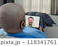 Remote therapy session: cancer patient connects with psychologist via tablet, illustrating the importance of mental health in treatment. 118341761